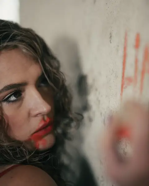 Maddison A beside the word LIAR written on a wall